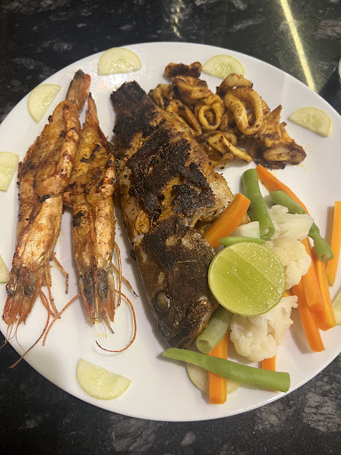 Seafood platter with grilled fish, prawns, squid and vegetables